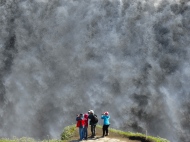 Tourists enjoying Dettifoss, the most powerful waterfall in Europe